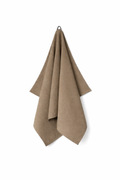 Brown towel hanging on a white background