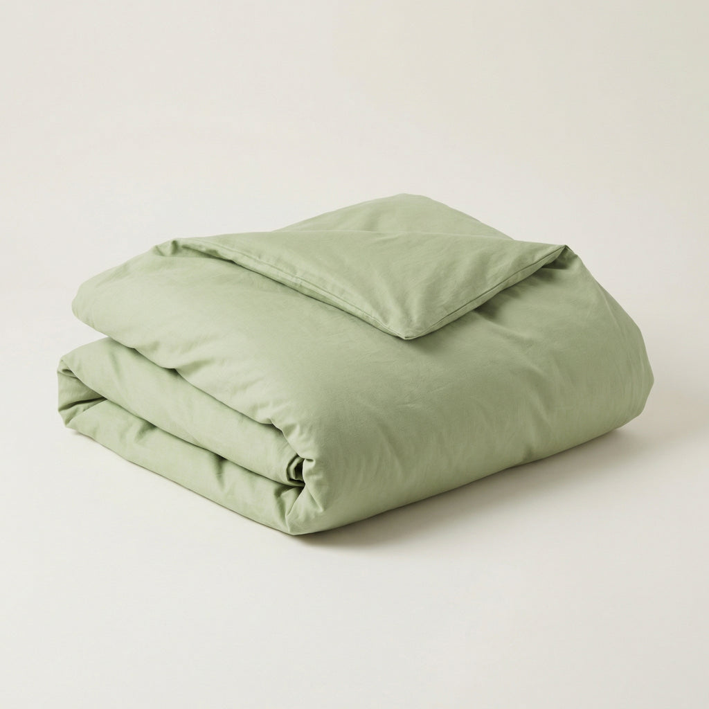 Folded spring green comforter on a white background