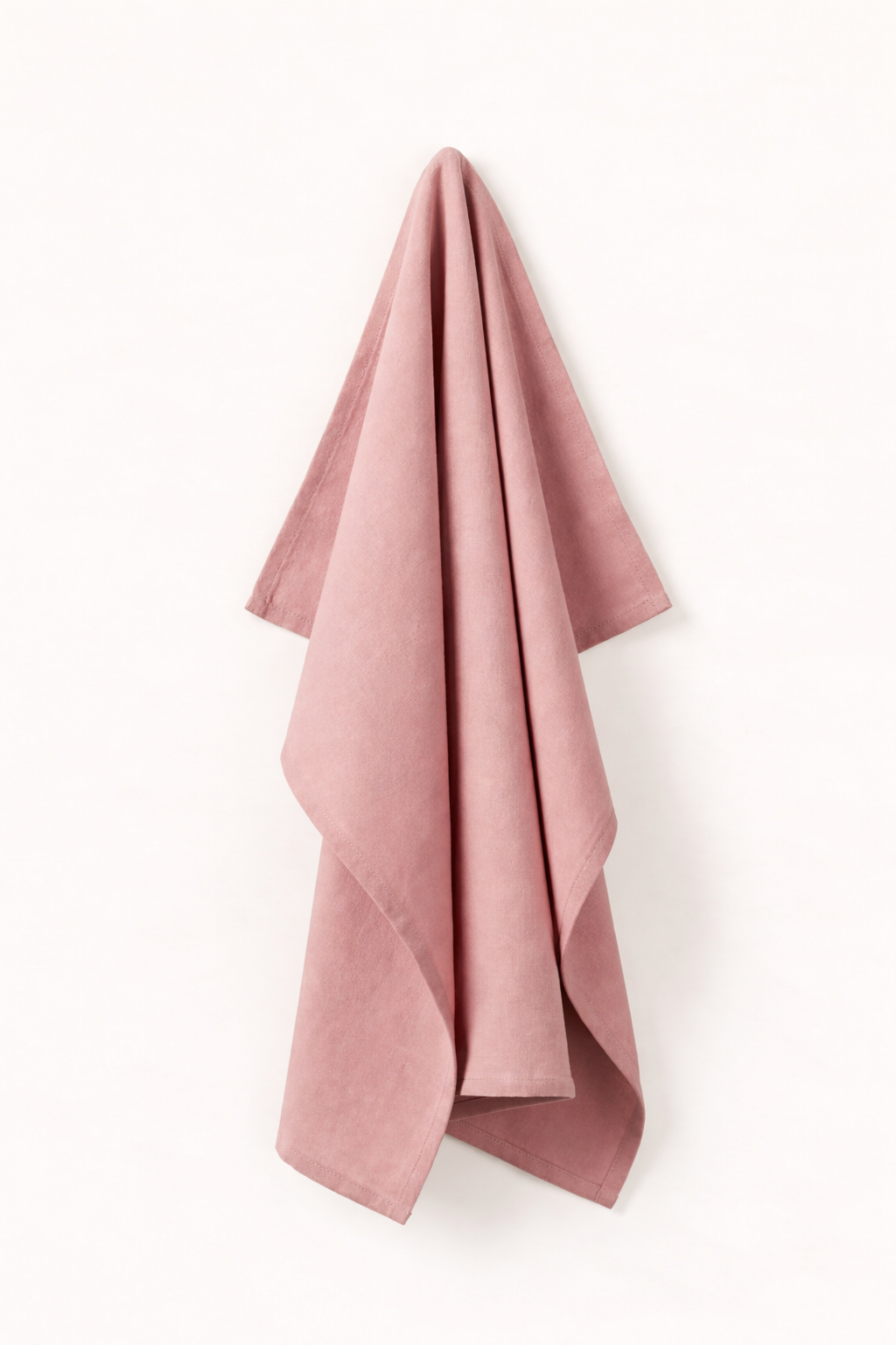 Rosa towel hanging on a white wall